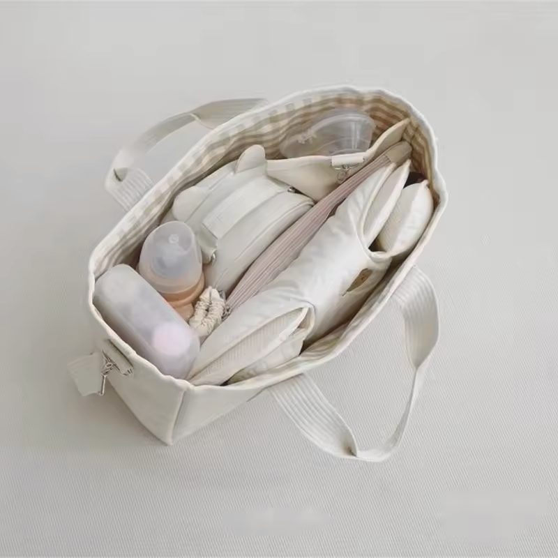 Baby Diaper Bag Handbag Style With Drawstring with baby essentials from a top view