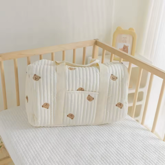 Large Mommy Diaper Bag Tote bear designs on a light wooden crib.