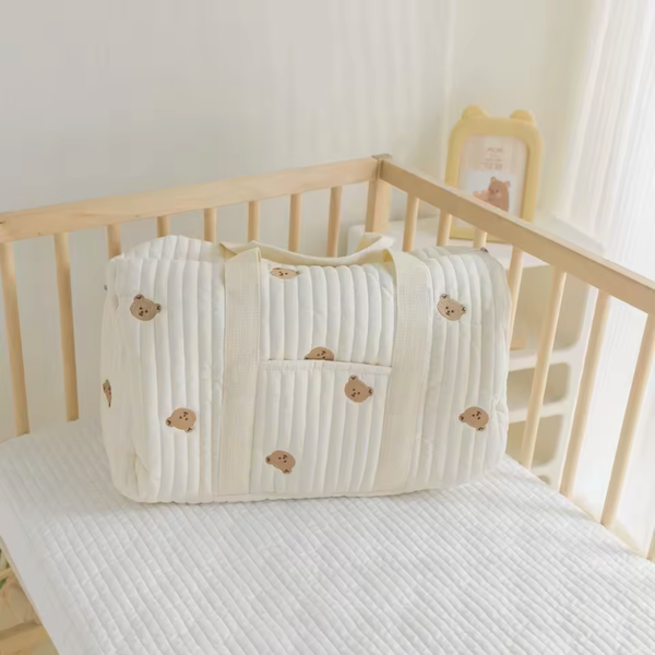 Large Mommy Diaper Bag Tote bear designs on a light wooden crib.